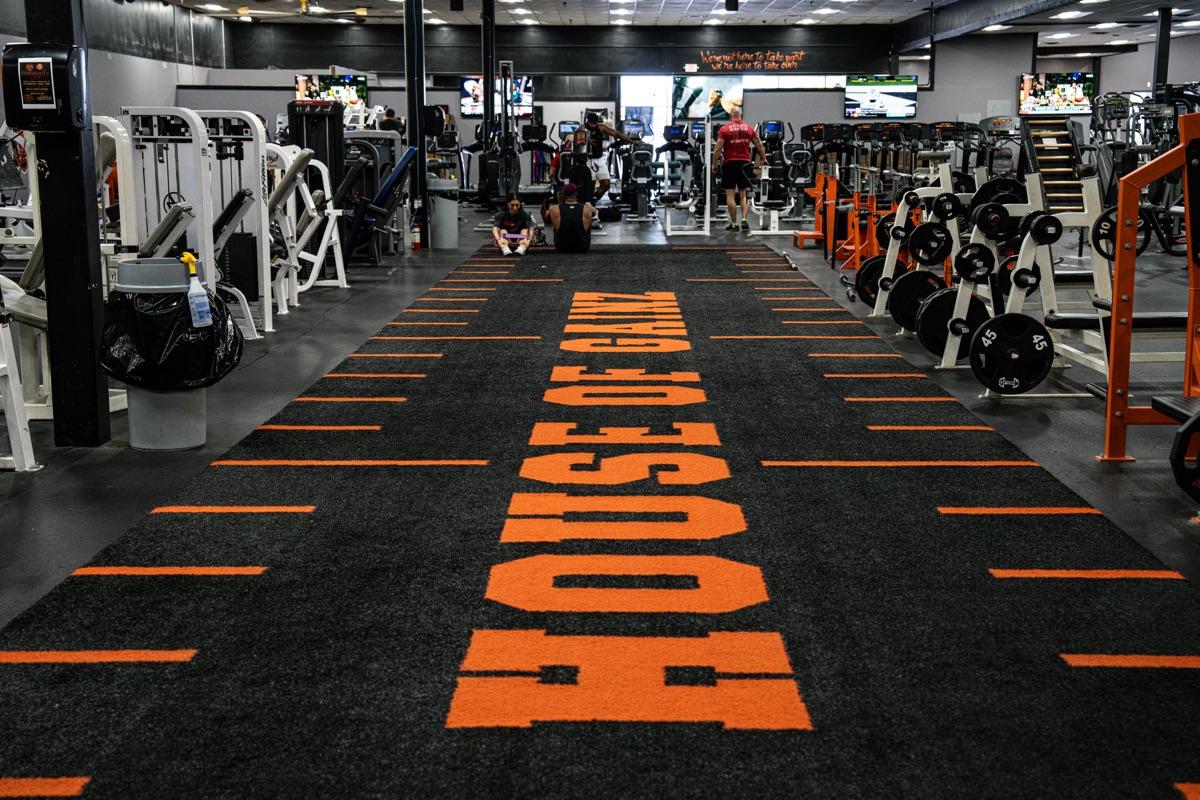House of Gainz branded turf walkway through the gym floor
